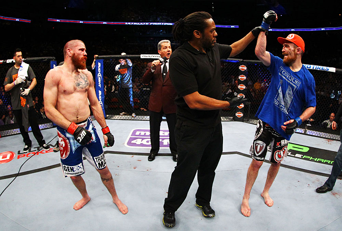 NEWARK, NJ - APRIL 27: Referee Herb Dean (C) raises the arm of winner Pat Healy (R) after defeating Jim Miller (L) by Technical Submission (rear-naked choke) in their lightweight bout during the UFC 159 event at the Prudential Center on April 27, 2013 in
