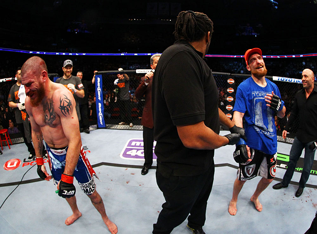 NEWARK, NJ - APRIL 27: Referee Herb Dean (C), Pat Healy (R) and Jim Miller (L) react after Bruce Buffer announces the wrong winner after their lightweight bout during the UFC 159 event at the Prudential Center on April 27, 2013 in Newark, New Jersey.