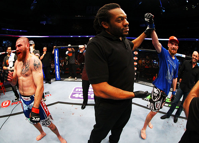 NEWARK, NJ - APRIL 27: Referee Herb Dean (C) raises the arm of winner Pat Healy (R) after defeating Jim Miller (L) by Technical Submission (rear-naked choke) in their lightweight bout during the UFC 159 event at the Prudential Center on April 27, 2013 in