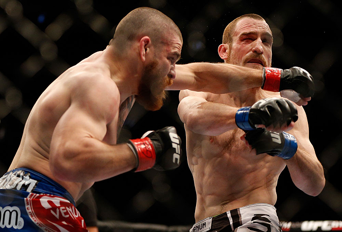 NEWARK, NJ - APRIL 27: (L-R) Jim Miller punches Pat Healy in their lightweight fight during the UFC 159 event at the Prudential Center on April 27, 2013 in Newark, New Jersey. (Photo by Josh Hedges/Zuffa LLC/Zuffa LLC via Getty Images)