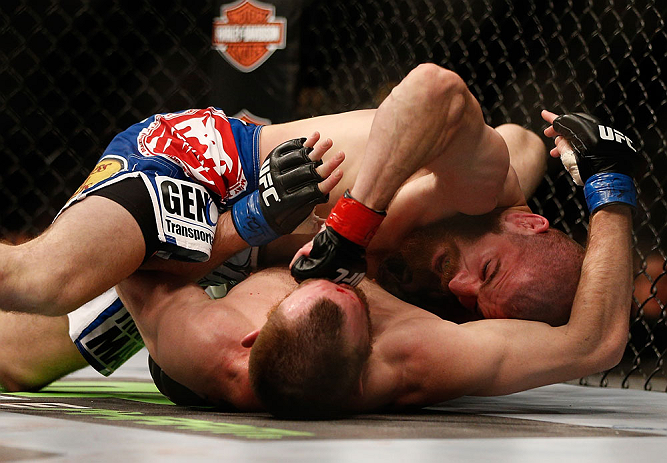 NEWARK, NJ - APRIL 27: Jim Miller (top) punches Pat Healy in their lightweight fight during the UFC 159 event at the Prudential Center on April 27, 2013 in Newark, New Jersey. (Photo by Josh Hedges/Zuffa LLC/Zuffa LLC via Getty Images)