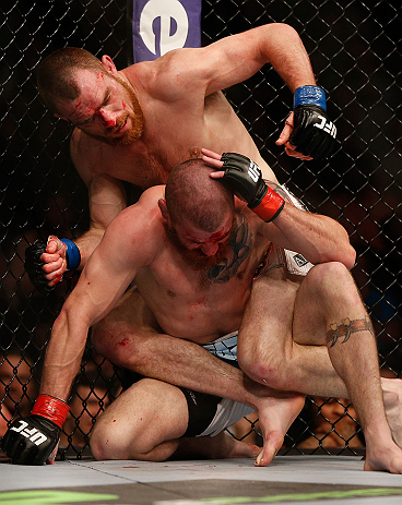 NEWARK, NJ - APRIL 27: Pat Healy (top) punches Jim Miller in their lightweight fight during the UFC 159 event at the Prudential Center on April 27, 2013 in Newark, New Jersey. (Photo by Josh Hedges/Zuffa LLC/Zuffa LLC via Getty Images)