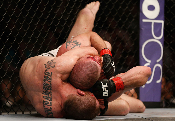 NEWARK, NJ - APRIL 27: (L-R) Pat Healy secures a rear choke submission against Jim Miller in their lightweight fight during the UFC 159 event at the Prudential Center on April 27, 2013 in Newark, New Jersey. (Photo by Josh Hedges/Zuffa LLC/Zuffa LLC vi