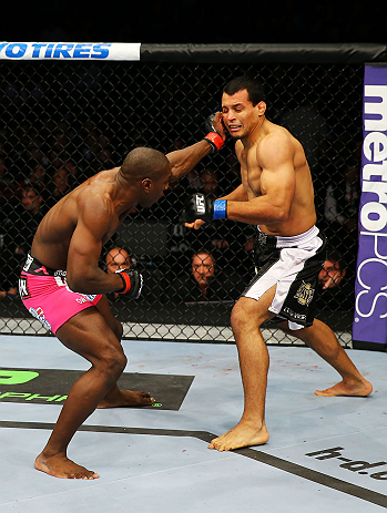 NEWARK, NJ - APRIL 27: (L-R) Phil Davis punches Vinny Magalhaes in their light heavyweight bout during the UFC 159 event at the Prudential Center on April 27, 2013 in Newark, New Jersey. (Photo by Al Bello/Zuffa LLC/Zuffa LLC Via Getty Images)