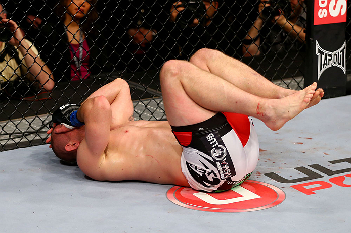 NEWARK, NJ - APRIL 27: Alan Belcher reacts after being poked in the eye in the third round of his middleweight bout against Michael Bisping of England during the UFC 159 event at the Prudential Center on April 27, 2013 in Newark, New Jersey. (Photo by A