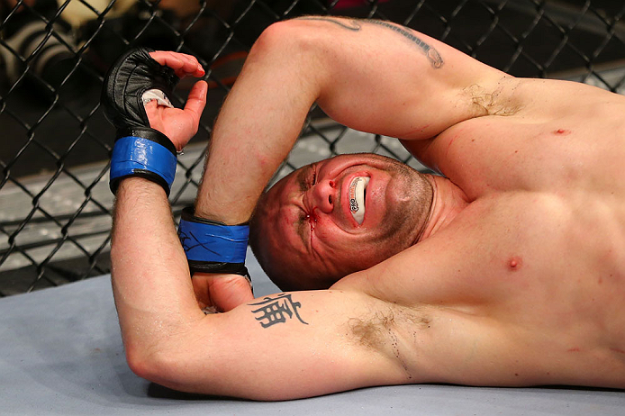 NEWARK, NJ - APRIL 27: Alan Belcher reacts after being poked in the eye in the third round of his middleweight bout against Michael Bisping of England during the UFC 159 event at the Prudential Center on April 27, 2013 in Newark, New Jersey. (Photo by A