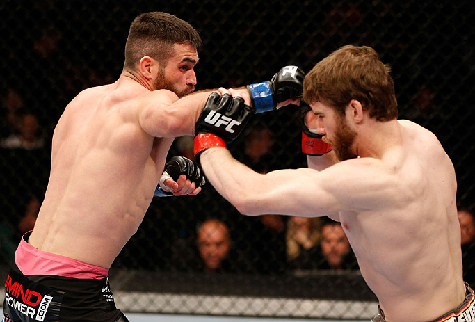 WINNIPEG, CANADA - JUNE 15: (L-R) John Maguire punches Mitch Clarke in their lightweight fight during the UFC 161 event at the MTS Centre on June 15, 2013 in Winnipeg, Manitoba, Canada. (Photo by Josh Hedges/Zuffa LLC/Zuffa LLC via Getty Images)