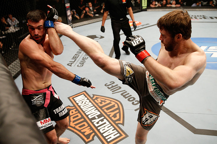 WINNIPEG, CANADA - JUNE 15: (R-L) Mitch Clarke kicks John Maguire in their lightweight fight during the UFC 161 event at the MTS Centre on June 15, 2013 in Winnipeg, Manitoba, Canada. (Photo by Josh Hedges/Zuffa LLC/Zuffa LLC via Getty Images)