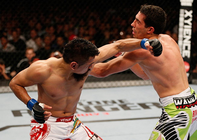 WINNIPEG, CANADA - JUNE 15: (L-R) Edwin Figueroa punches Roland Delorme in their bantamweight fight during the UFC 161 event at the MTS Centre on June 15, 2013 in Winnipeg, Manitoba, Canada. (Photo by Josh Hedges/Zuffa LLC/Zuffa LLC via Getty Images)