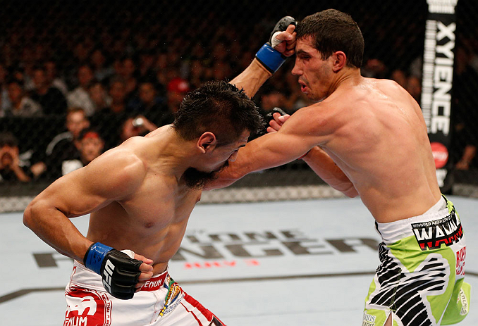 WINNIPEG, CANADA - JUNE 15: (L-R) Edwin Figueroa punches Roland Delorme in their bantamweight fight during the UFC 161 event at the MTS Centre on June 15, 2013 in Winnipeg, Manitoba, Canada. (Photo by Josh Hedges/Zuffa LLC/Zuffa LLC via Getty Images)