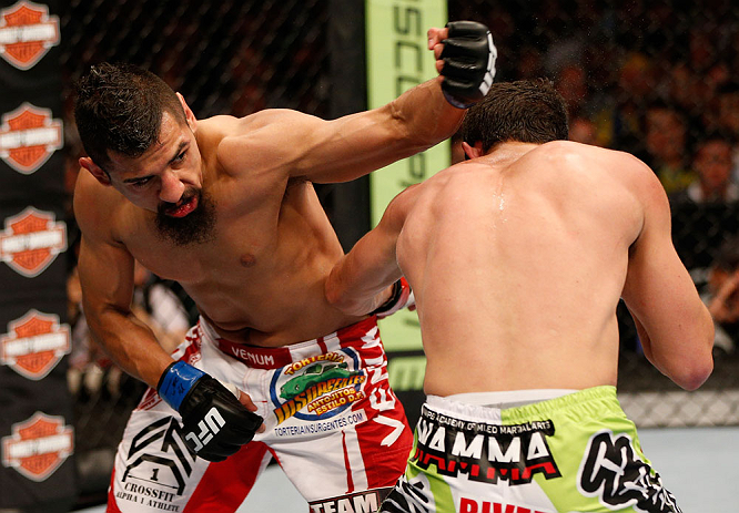 WINNIPEG, CANADA - JUNE 15: (L-R) Edwin Figueroa punches Roland Delorme in their bantamweight fight during the UFC 161 event at the MTS Centre on June 15, 2013 in Winnipeg, Manitoba, Canada. (Photo by Josh Hedges/Zuffa LLC/Zuffa LLC via Getty Images)