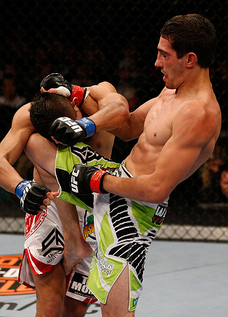 WINNIPEG, CANADA - JUNE 15: (R-L) Roland Delorme knees Edwin Figueroa in their bantamweight fight during the UFC 161 event at the MTS Centre on June 15, 2013 in Winnipeg, Manitoba, Canada. (Photo by Josh Hedges/Zuffa LLC/Zuffa LLC via Getty Images)