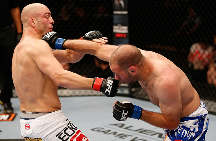 WINNIPEG, CANADA - JUNE 15: (R-L) Kenny Robertson punches Sean Pierson in their welterweight fight during the UFC 161 event at the MTS Centre on June 15, 2013 in Winnipeg, Manitoba, Canada. (Photo by Josh Hedges/Zuffa LLC/Zuffa LLC via Getty Images)