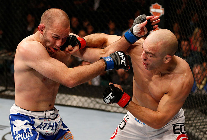 WINNIPEG, CANADA - JUNE 15: (R-L) Sean Pierson punches Kenny Robertson in their welterweight fight during the UFC 161 event at the MTS Centre on June 15, 2013 in Winnipeg, Manitoba, Canada. (Photo by Josh Hedges/Zuffa LLC/Zuffa LLC via Getty Images)