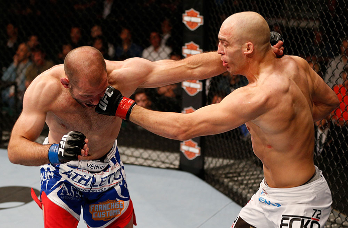 WINNIPEG, CANADA - JUNE 15: (R-L) Sean Pierson punches Kenny Robertson in their welterweight fight during the UFC 161 event at the MTS Centre on June 15, 2013 in Winnipeg, Manitoba, Canada. (Photo by Josh Hedges/Zuffa LLC/Zuffa LLC via Getty Images)