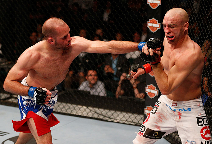 WINNIPEG, CANADA - JUNE 15: (L-R) Kenny Robertson punches Sean Pierson in their welterweight fight during the UFC 161 event at the MTS Centre on June 15, 2013 in Winnipeg, Manitoba, Canada. (Photo by Josh Hedges/Zuffa LLC/Zuffa LLC via Getty Images)