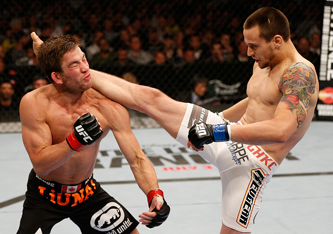 WINNIPEG, CANADA - JUNE 15: (R-L) James Krause kicks Sam Stout in their lightweight fight during the UFC 161 event at the MTS Centre on June 15, 2013 in Winnipeg, Manitoba, Canada. (Photo by Josh Hedges/Zuffa LLC/Zuffa LLC via Getty Images)