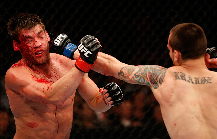 WINNIPEG, CANADA - JUNE 15: (R-L) James Krause punches Sam Stout in their lightweight fight during the UFC 161 event at the MTS Centre on June 15, 2013 in Winnipeg, Manitoba, Canada. (Photo by Josh Hedges/Zuffa LLC/Zuffa LLC via Getty Images)