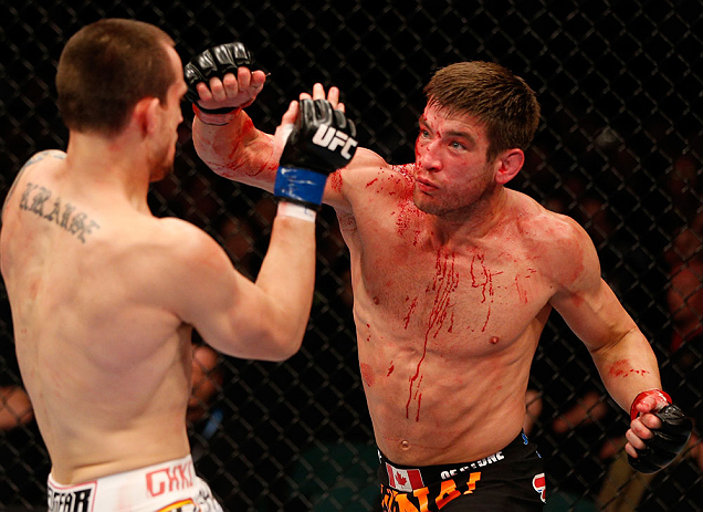 WINNIPEG, CANADA - JUNE 15: (R-L) Sam Stout punches James Krause in their lightweight fight during the UFC 161 event at the MTS Centre on June 15, 2013 in Winnipeg, Manitoba, Canada. (Photo by Josh Hedges/Zuffa LLC/Zuffa LLC via Getty Images)