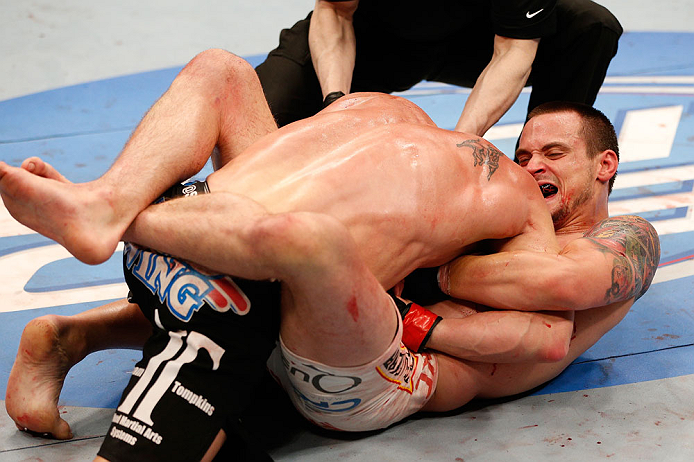 WINNIPEG, CANADA - JUNE 15: (R-L) James Krause secures a guillotine choke submission against Sam Stout in their lightweight fight during the UFC 161 event at the MTS Centre on June 15, 2013 in Winnipeg, Manitoba, Canada. (Photo by Josh Hedges/Zuffa LLC/