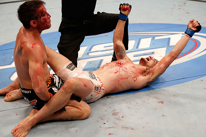 WINNIPEG, CANADA - JUNE 15: James Krause (R) reacts after his submission victory over Sam Stout (L) in their lightweight fight during the UFC 161 event at the MTS Centre on June 15, 2013 in Winnipeg, Manitoba, Canada. (Photo by Josh Hedges/Zuffa LLC/Zuf