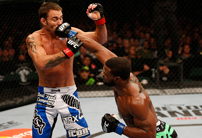WINNIPEG, CANADA - JUNE 15: (R-L) Tyron Woodley punches Jake Shields in their welterweight fight during the UFC 161 event at the MTS Centre on June 15, 2013 in Winnipeg, Manitoba, Canada. (Photo by Josh Hedges/Zuffa LLC/Zuffa LLC via Getty Images)