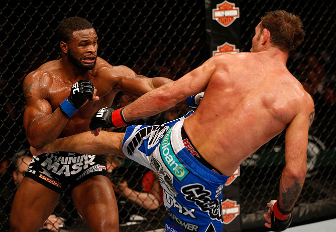 WINNIPEG, CANADA - JUNE 15: (R-L) Jake Shields kicks Tyron Woodley in their welterweight fight during the UFC 161 event at the MTS Centre on June 15, 2013 in Winnipeg, Manitoba, Canada. (Photo by Josh Hedges/Zuffa LLC/Zuffa LLC via Getty Images)