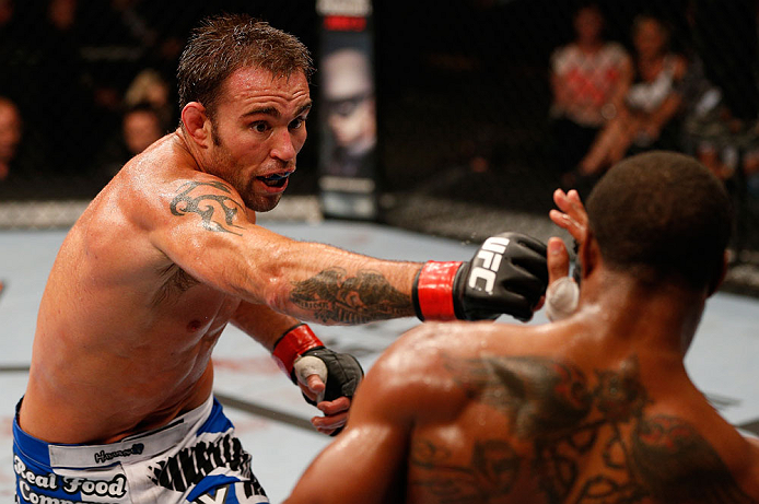 WINNIPEG, CANADA - JUNE 15: (L-R) Jake Shields punches Tyron Woodley in their welterweight fight during the UFC 161 event at the MTS Centre on June 15, 2013 in Winnipeg, Manitoba, Canada. (Photo by Josh Hedges/Zuffa LLC/Zuffa LLC via Getty Images)