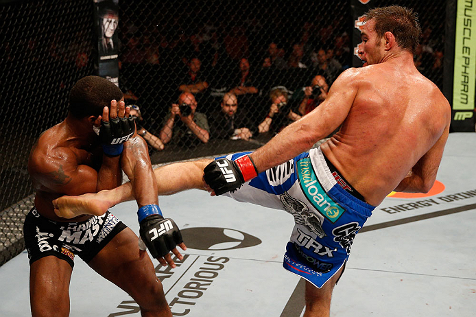 WINNIPEG, CANADA - JUNE 15: (R-L) Jake Shields kicks Tyron Woodley in their welterweight fight during the UFC 161 event at the MTS Centre on June 15, 2013 in Winnipeg, Manitoba, Canada. (Photo by Josh Hedges/Zuffa LLC/Zuffa LLC via Getty Images)