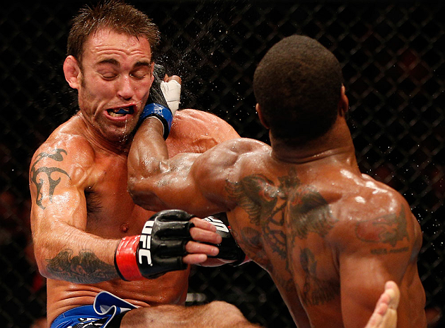WINNIPEG, CANADA - JUNE 15: (R-L) Tyron Woodley lands a spinning back fist against Jake Shields in their welterweight fight during the UFC 161 event at the MTS Centre on June 15, 2013 in Winnipeg, Manitoba, Canada. (Photo by Josh Hedges/Zuffa LLC/Zuffa