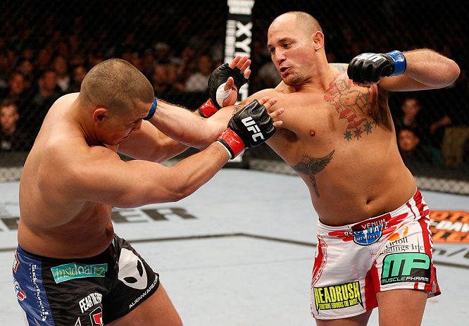 WINNIPEG, CANADA - JUNE 15: (R-L) Shawn Jordan punches Pat Barry in their heavyweight fight during the UFC 161 event at the MTS Centre on June 15, 2013 in Winnipeg, Manitoba, Canada. (Photo by Josh Hedges/Zuffa LLC/Zuffa LLC via Getty Images)