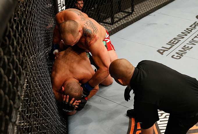 WINNIPEG, CANADA - JUNE 15: (R-L) Shawn Jordan punches Pat Barry in their heavyweight fight during the UFC 161 event at the MTS Centre on June 15, 2013 in Winnipeg, Manitoba, Canada. (Photo by Josh Hedges/Zuffa LLC/Zuffa LLC via Getty Images)