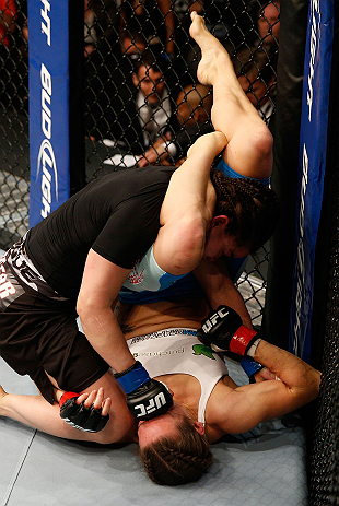 WINNIPEG, CANADA - JUNE 15: Rosi Sexton (top) punches Alexis Davis as she attempts a triangle choke in their bantamweight fight during the UFC 161 event at the MTS Centre on June 15, 2013 in Winnipeg, Manitoba, Canada. (Photo by Josh Hedges/Zuffa LLC/Zu