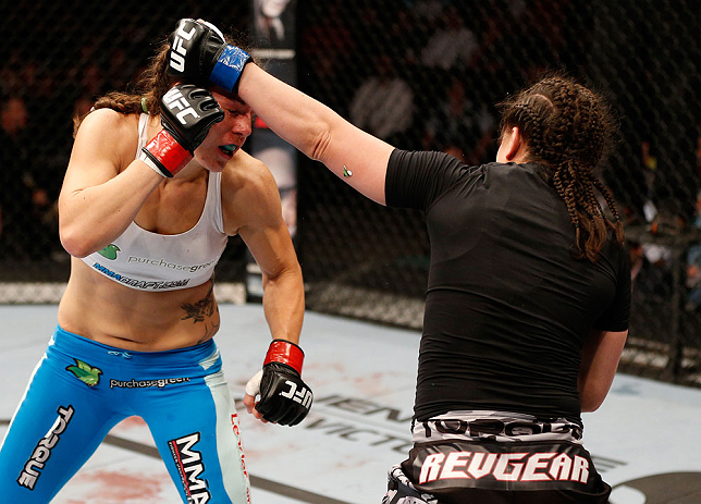 WINNIPEG, CANADA - JUNE 15: (R-L) Rosi Sexton punches Alexis Davis in their bantamweight fight during the UFC 161 event at the MTS Centre on June 15, 2013 in Winnipeg, Manitoba, Canada. (Photo by Josh Hedges/Zuffa LLC/Zuffa LLC via Getty Images)