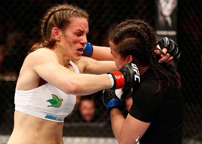 WINNIPEG, CANADA - JUNE 15: (L-R) Alexis Davis and Rosi Sexton trade punches in their bantamweight fight during the UFC 161 event at the MTS Centre on June 15, 2013 in Winnipeg, Manitoba, Canada. (Photo by Josh Hedges/Zuffa LLC/Zuffa LLC via Getty Image