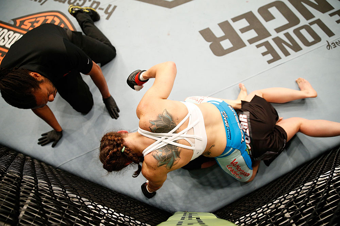 WINNIPEG, CANADA - JUNE 15: Alexis Davis punches down at Rosi Sexton in their bantamweight fight during the UFC 161 event at the MTS Centre on June 15, 2013 in Winnipeg, Manitoba, Canada. (Photo by Josh Hedges/Zuffa LLC/Zuffa LLC via Getty Images)