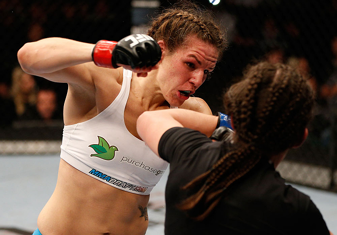 WINNIPEG, CANADA - JUNE 15: (L-R) Alexis Davis punches Rosi Sexton in their bantamweight fight during the UFC 161 event at the MTS Centre on June 15, 2013 in Winnipeg, Manitoba, Canada. (Photo by Josh Hedges/Zuffa LLC/Zuffa LLC via Getty Images)