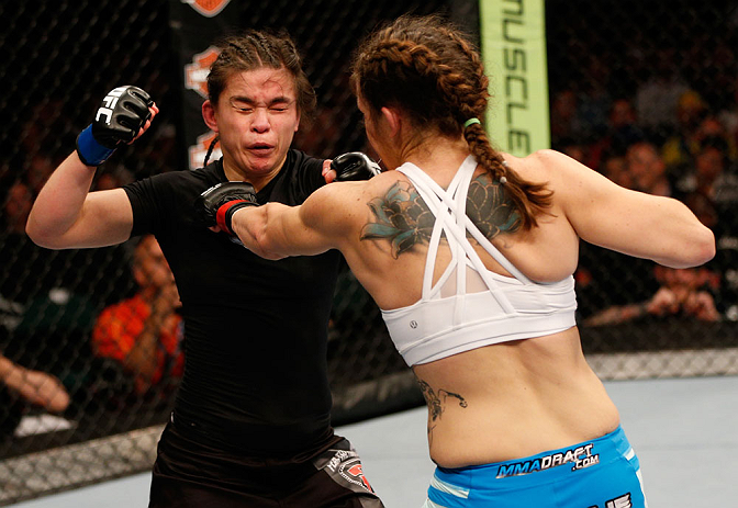 WINNIPEG, CANADA - JUNE 15: (R-L) Alexis Davis punches Rosi Sexton in their bantamweight fight during the UFC 161 event at the MTS Centre on June 15, 2013 in Winnipeg, Manitoba, Canada. (Photo by Josh Hedges/Zuffa LLC/Zuffa LLC via Getty Images)