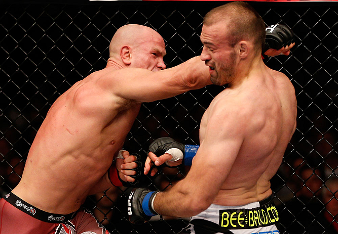 WINNIPEG, CANADA - JUNE 15: (L-R) Ryan Jimmo punches Igor Pokrajac in their light heavyweight fight during the UFC 161 event at the MTS Centre on June 15, 2013 in Winnipeg, Manitoba, Canada. (Photo by Josh Hedges/Zuffa LLC/Zuffa LLC via Getty Images)
