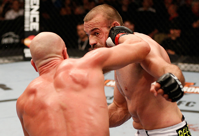 WINNIPEG, CANADA - JUNE 15: (L-R) Ryan Jimmo punches Igor Pokrajac in their light heavyweight fight during the UFC 161 event at the MTS Centre on June 15, 2013 in Winnipeg, Manitoba, Canada. (Photo by Josh Hedges/Zuffa LLC/Zuffa LLC via Getty Images)