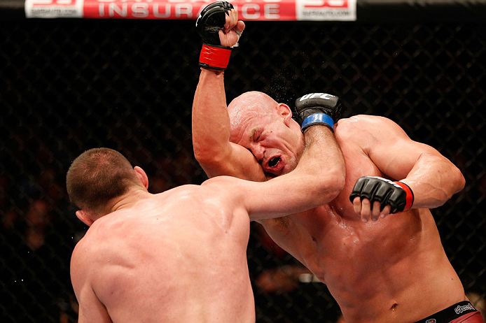 WINNIPEG, CANADA - JUNE 15: (L-R) Igor Pokrajac punches Ryan Jimmo in their light heavyweight fight during the UFC 161 event at the MTS Centre on June 15, 2013 in Winnipeg, Manitoba, Canada. (Photo by Josh Hedges/Zuffa LLC/Zuffa LLC via Getty Images)