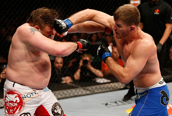 WINNIPEG, CANADA - JUNE 15: (R-L) Stipe Miocic punches "Big Country" Roy Nelson in their heavyweight fight during the UFC 161 event at the MTS Centre on June 15, 2013 in Winnipeg, Manitoba, Canada. (Photo by Josh Hedges/Zuffa LLC/Zuffa LLC via Getty Ima