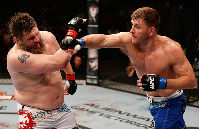 WINNIPEG, CANADA - JUNE 15: (R-L) Stipe Miocic punches "Big Country" Roy Nelson in their heavyweight fight during the UFC 161 event at the MTS Centre on June 15, 2013 in Winnipeg, Manitoba, Canada. (Photo by Josh Hedges/Zuffa LLC/Zuffa LLC via Getty Ima