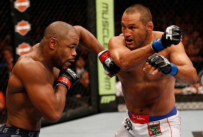 WINNIPEG, CANADA - JUNE 15: (R-L) Dan Henderson punches Rashad Evans in their light heavyweight fight during the UFC 161 event at the MTS Centre on June 15, 2013 in Winnipeg, Manitoba, Canada. (Photo by Josh Hedges/Zuffa LLC/Zuffa LLC via Getty Images)