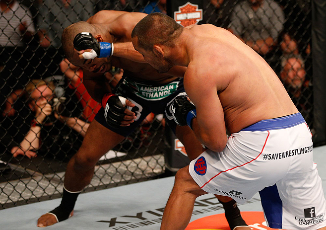 WINNIPEG, CANADA - JUNE 15: (R-L) Dan Henderson punches Rashad Evans in their light heavyweight fight during the UFC 161 event at the MTS Centre on June 15, 2013 in Winnipeg, Manitoba, Canada. (Photo by Josh Hedges/Zuffa LLC/Zuffa LLC via Getty Images)