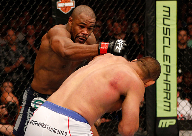 WINNIPEG, CANADA - JUNE 15: (L-R) Rashad Evans punches Dan Henderson in their light heavyweight fight during the UFC 161 event at the MTS Centre on June 15, 2013 in Winnipeg, Manitoba, Canada. (Photo by Josh Hedges/Zuffa LLC/Zuffa LLC via Getty Images)