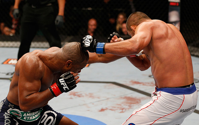 WINNIPEG, CANADA - JUNE 15: (L-R) Rashad Evans punches Dan Henderson in their light heavyweight fight during the UFC 161 event at the MTS Centre on June 15, 2013 in Winnipeg, Manitoba, Canada. (Photo by Josh Hedges/Zuffa LLC/Zuffa LLC via Getty Images)