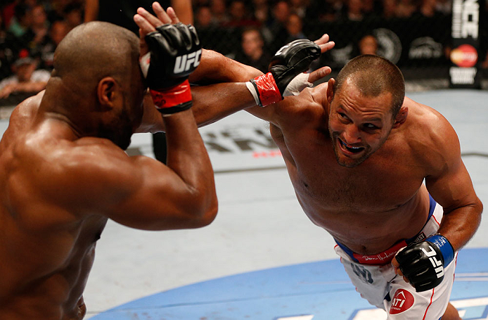 WINNIPEG, CANADA - JUNE 15: (R-L) Dan Henderson punches Rashad Evans in their light heavyweight fight during the UFC 161 event at the MTS Centre on June 15, 2013 in Winnipeg, Manitoba, Canada. (Photo by Josh Hedges/Zuffa LLC/Zuffa LLC via Getty Images)