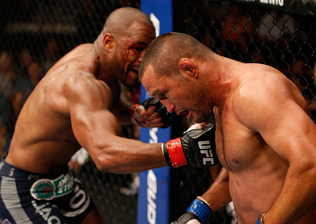 WINNIPEG, CANADA - JUNE 15: (L-R) Rashad Evans punches Dan Henderson in their light heavyweight fight during the UFC 161 event at the MTS Centre on June 15, 2013 in Winnipeg, Manitoba, Canada. (Photo by Josh Hedges/Zuffa LLC/Zuffa LLC via Getty Images)