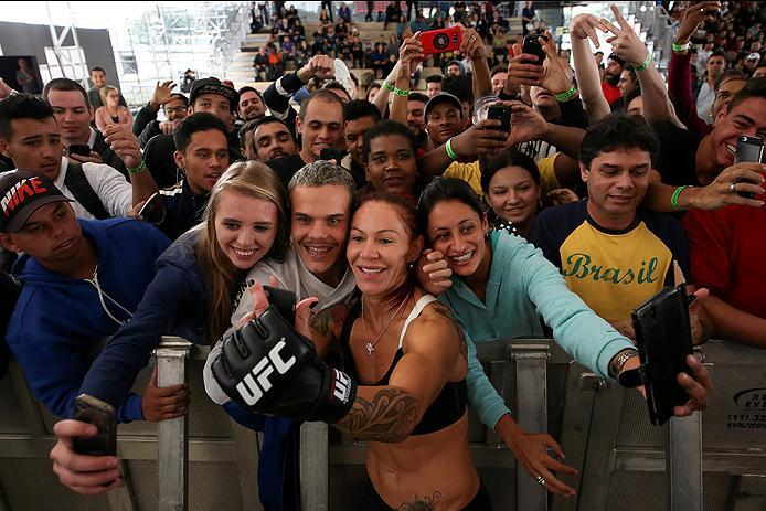 RIO DE JANEIRO, BRAZIL - MAY 11: Catchweight Cris "Cyborg" Justino of Brazil takes photos with fans during an open training session at Arena da Baixada stadium on May 11, 2016 in Curitiba, Brazil. (Photo by Buda Mendes/Zuffa LLC/Zuffa LLC via Getty Images